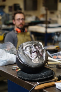 a face engraved in metal