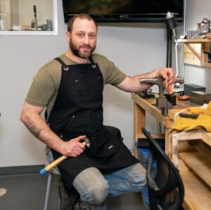 A man sitting in a chair holding an object.