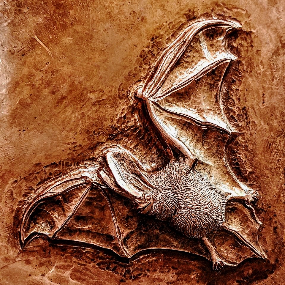 a bat carved in metal