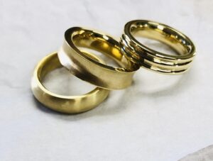 three metal gold rings