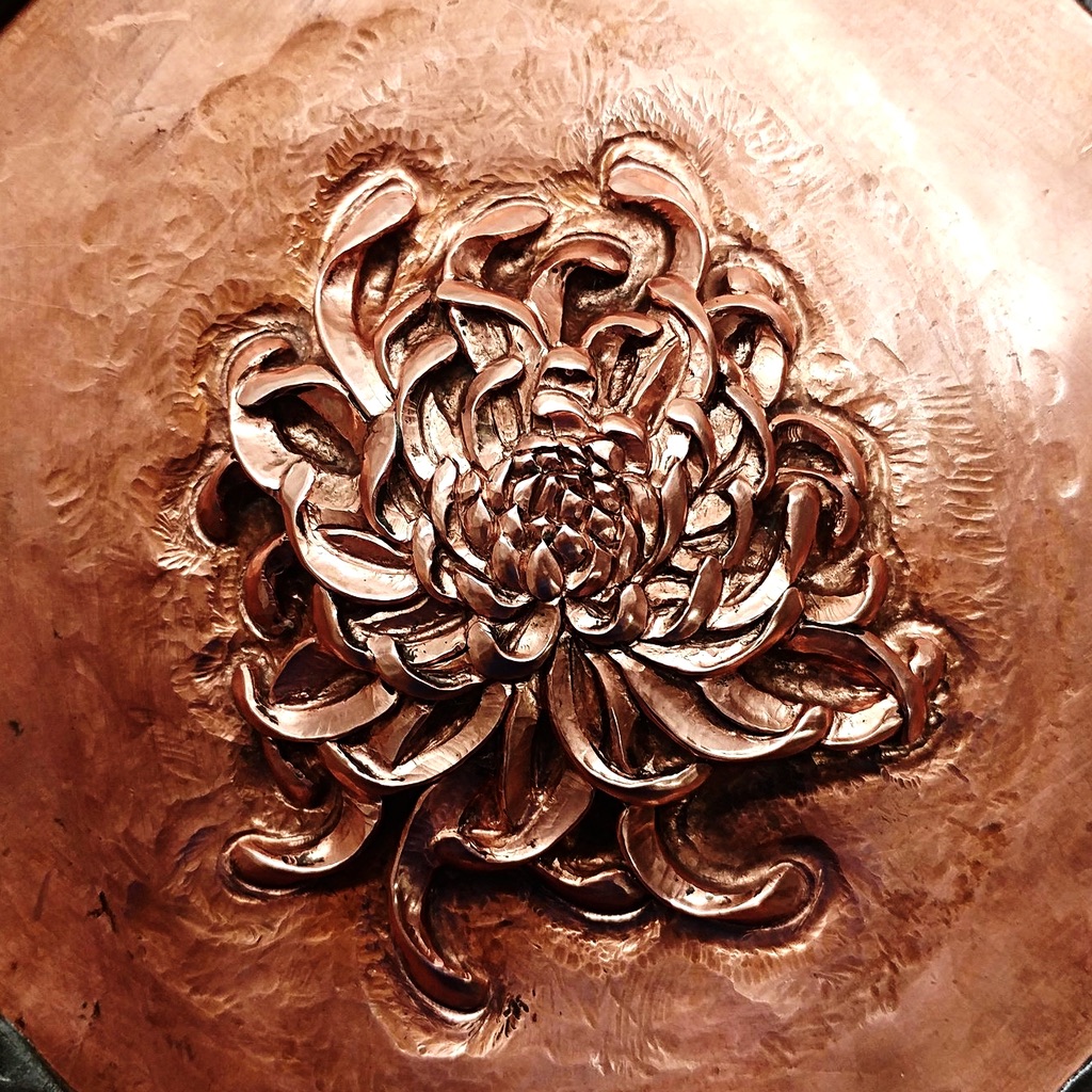 a flower carved in metal