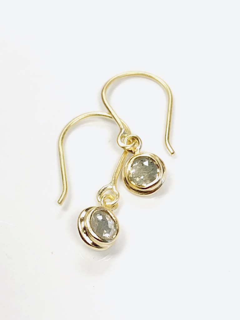 two gold earrings with gems