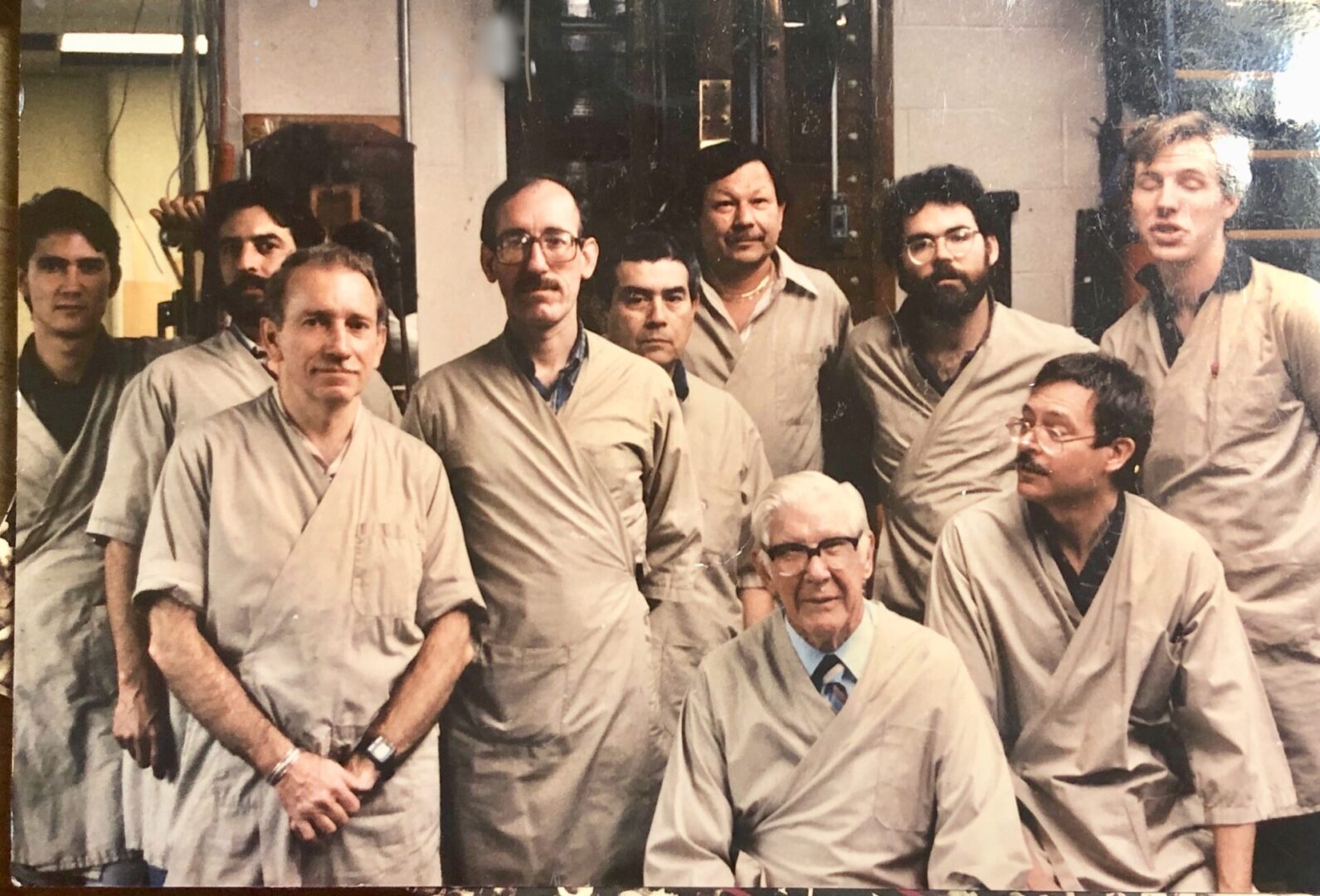 A group of men in tan shirts and ties.