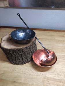 A couple of bowls sitting on top of a tree stump.