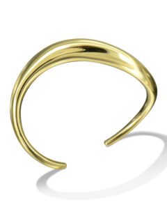 A gold bracelet with a curved design on it.