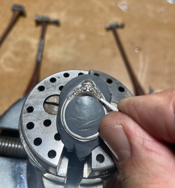 A person is working on a ring